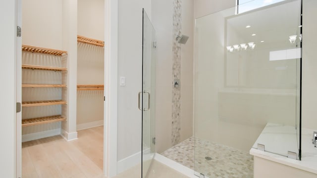 bathroom with wood-type flooring and walk in shower