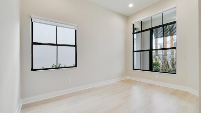 empty room with light hardwood / wood-style flooring