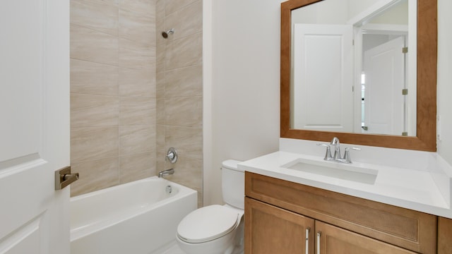 full bathroom with tiled shower / bath, vanity, and toilet