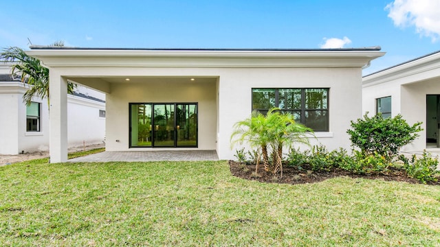 rear view of property featuring a patio and a yard