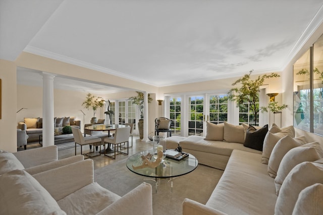 living room featuring ornate columns, french doors, and ornamental molding