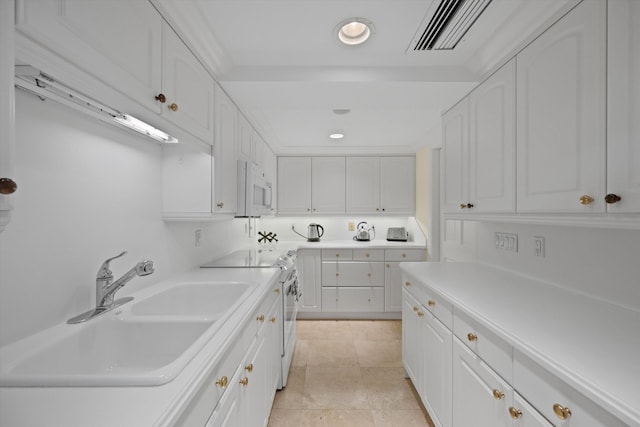 kitchen featuring white cabinets, white appliances, and sink