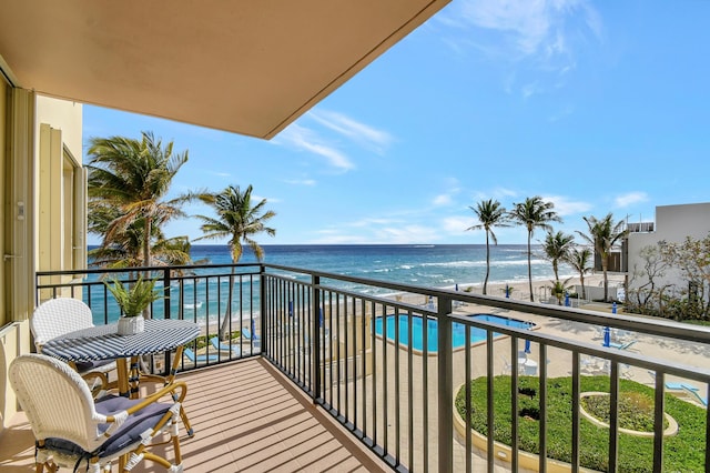 balcony with a water view and a beach view