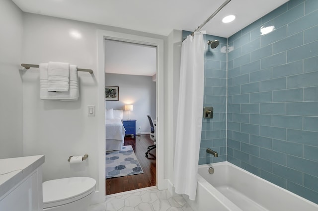 full bathroom featuring shower / tub combo, vanity, toilet, and tile patterned flooring