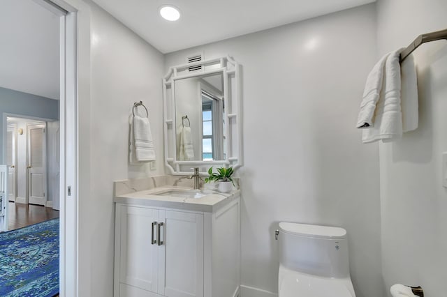 bathroom with vanity and toilet