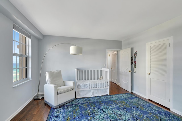 unfurnished bedroom with dark hardwood / wood-style flooring and multiple windows