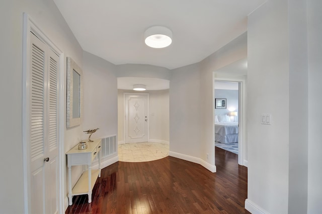 hallway featuring dark hardwood / wood-style floors