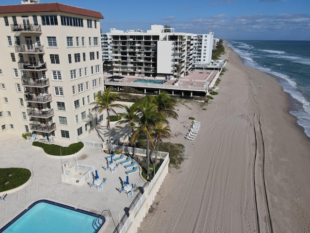 bird's eye view with a water view and a beach view