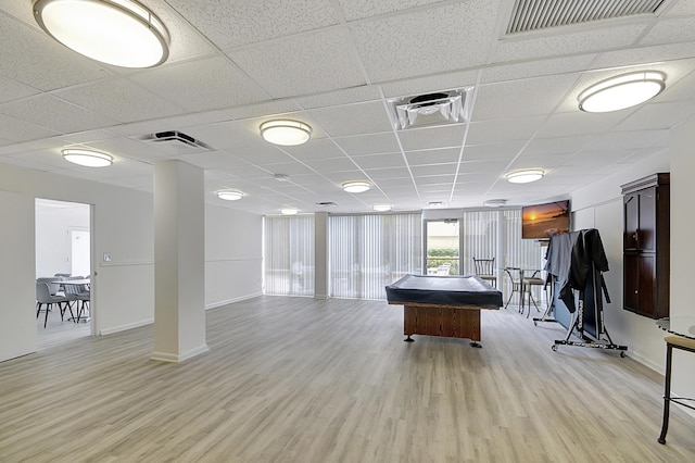 game room with light hardwood / wood-style flooring and a drop ceiling