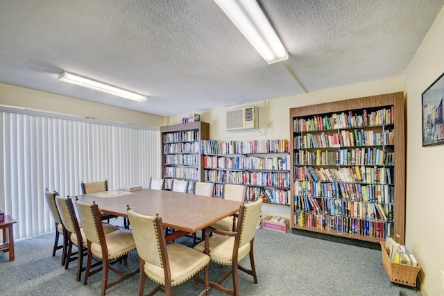 carpeted dining room with a wall mounted air conditioner and a textured ceiling