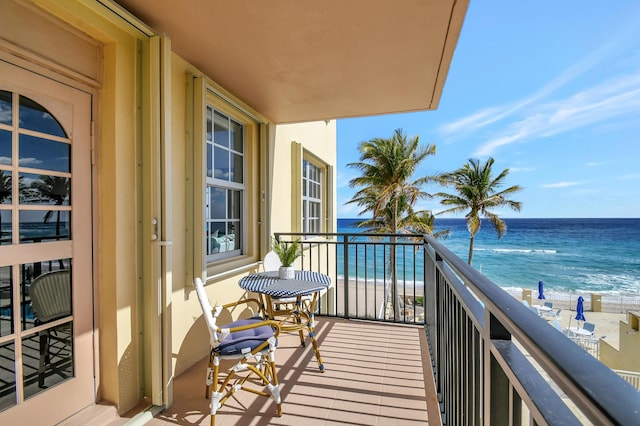 balcony with a view of the beach and a water view