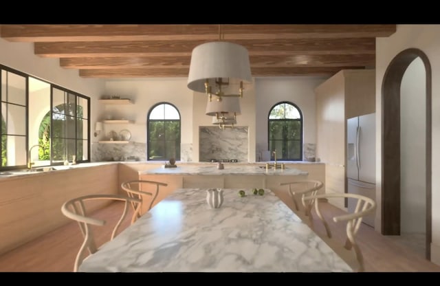 dining room with beamed ceiling and sink