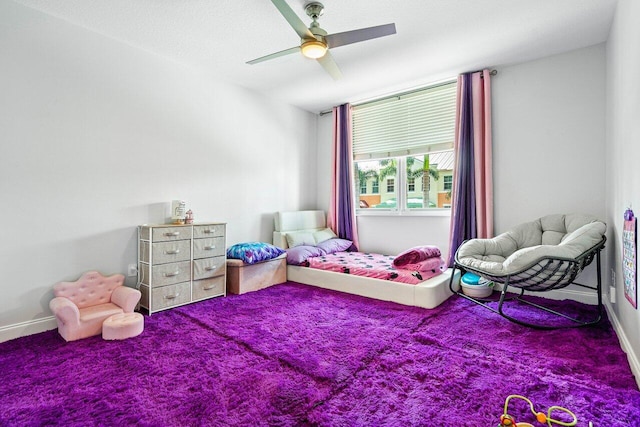 carpeted bedroom featuring ceiling fan and baseboards