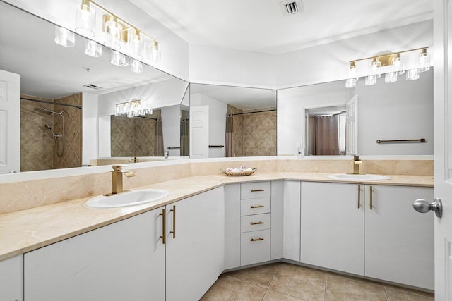 bathroom featuring a shower, visible vents, vanity, and tile patterned floors