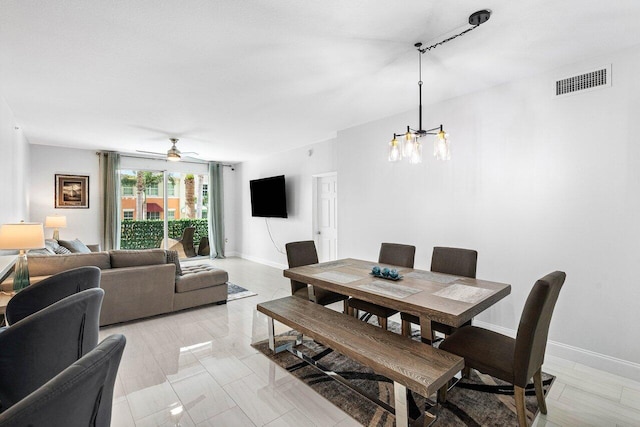 dining area with visible vents, baseboards, and ceiling fan with notable chandelier