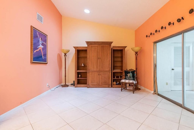 interior space featuring light tile patterned floors and lofted ceiling