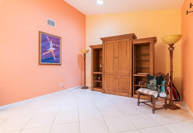 sitting room with light tile patterned flooring and lofted ceiling