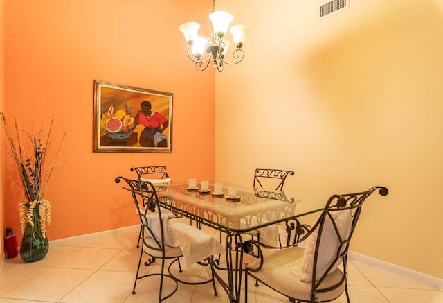 dining room featuring a notable chandelier and light tile patterned flooring