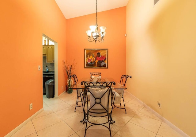 dining area with light tile patterned flooring, high vaulted ceiling, and an inviting chandelier