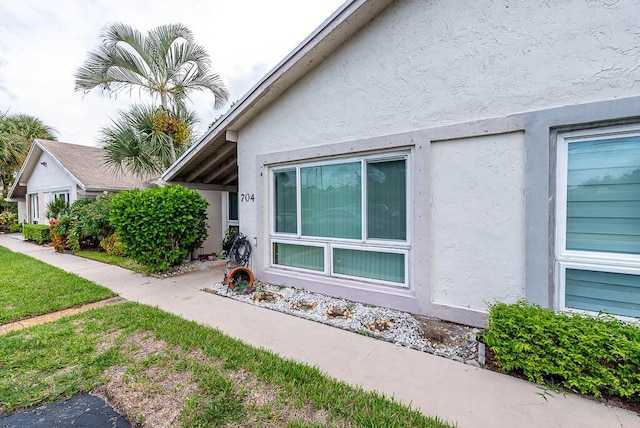 view of side of home featuring a lawn