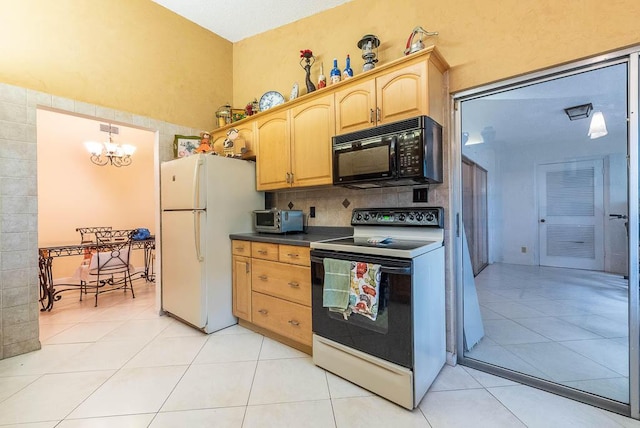 kitchen with light tile patterned floors, white appliances, an inviting chandelier, and pendant lighting