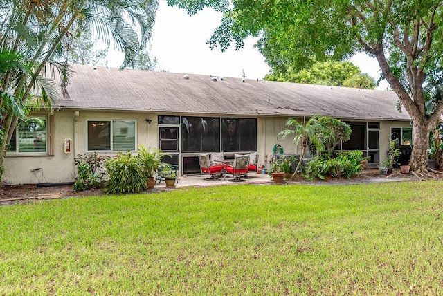 rear view of house with a patio area and a lawn