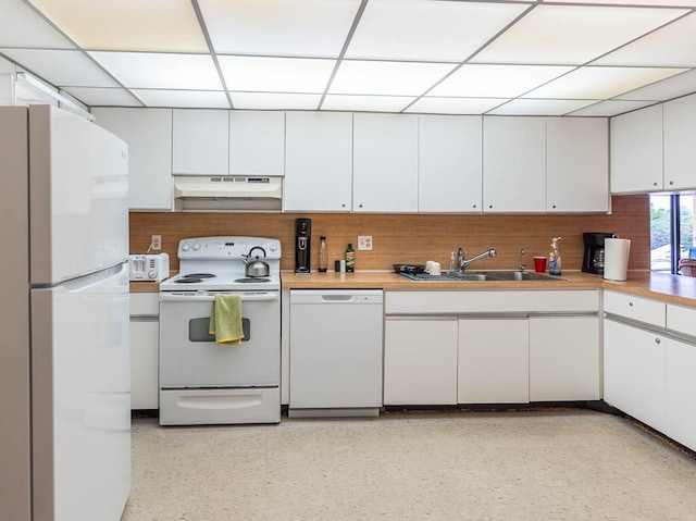 kitchen with white cabinets, white appliances, a drop ceiling, and sink