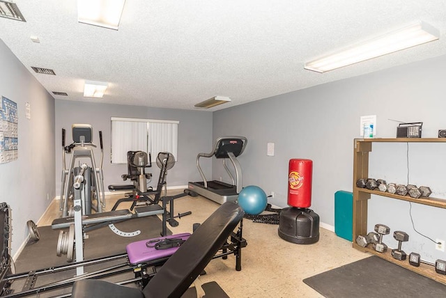 workout area featuring a textured ceiling