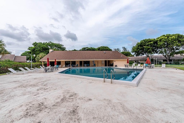 view of swimming pool with a patio