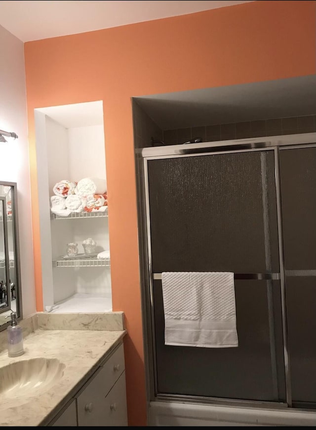 bathroom featuring vanity and an enclosed shower