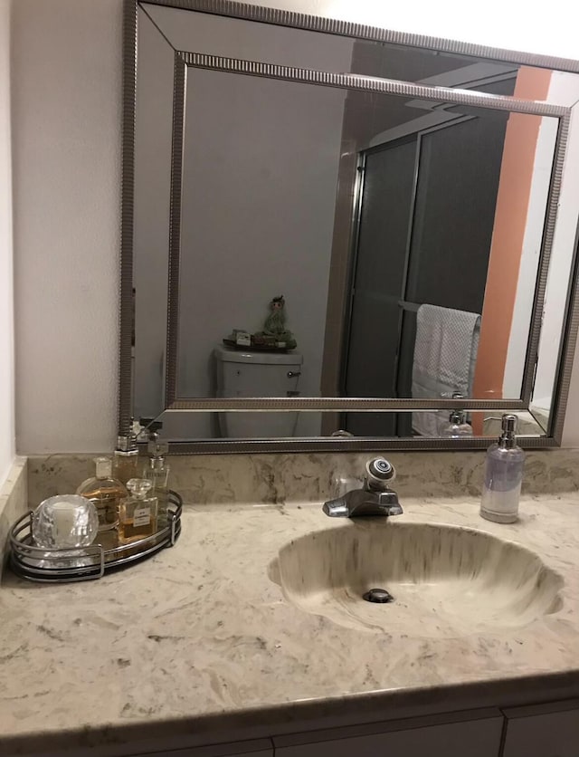 bathroom with vanity and toilet