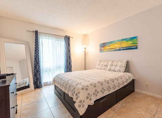 bedroom with light tile patterned flooring and a textured ceiling