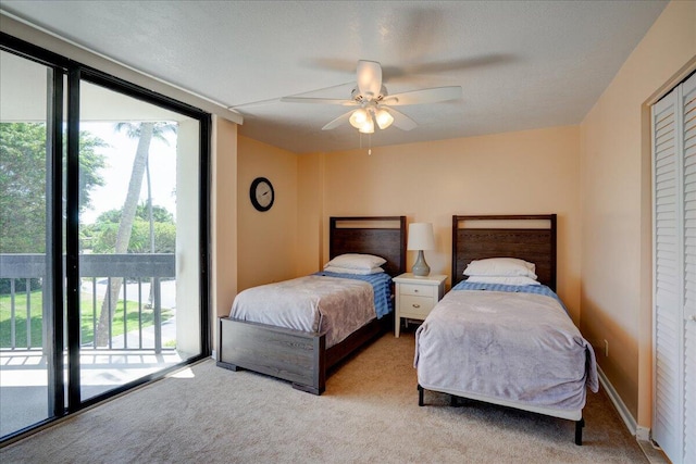 carpeted bedroom with ceiling fan and access to exterior