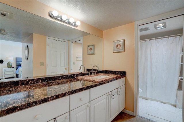 bathroom featuring vanity, a shower with shower curtain, a textured ceiling, and toilet