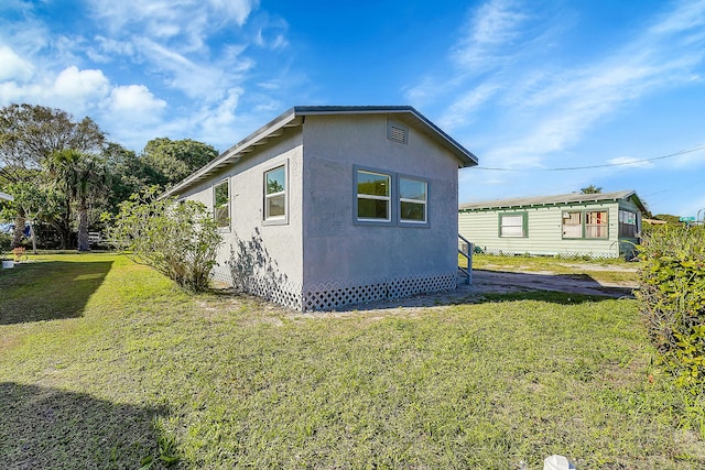 view of home's exterior featuring a lawn