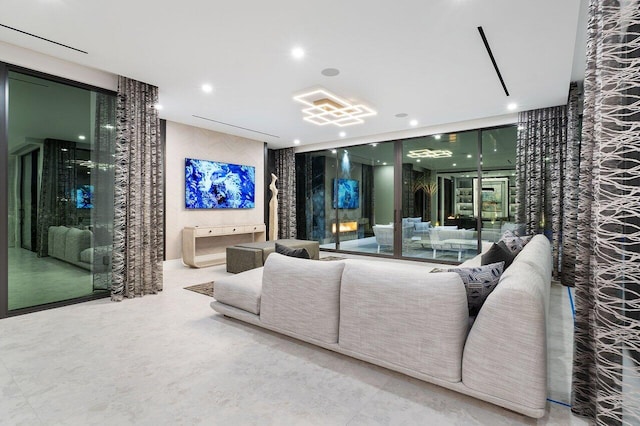 living area featuring a wall of windows and recessed lighting