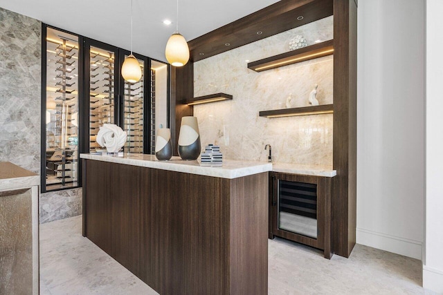 wine room featuring beverage cooler and wet bar