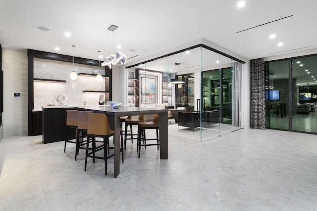 interior space with hanging light fixtures, a wall of windows, backsplash, and recessed lighting