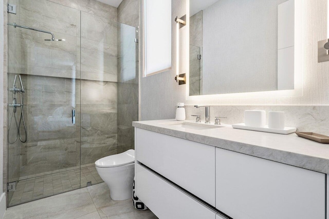 bathroom with toilet, vanity, marble finish floor, backsplash, and a stall shower