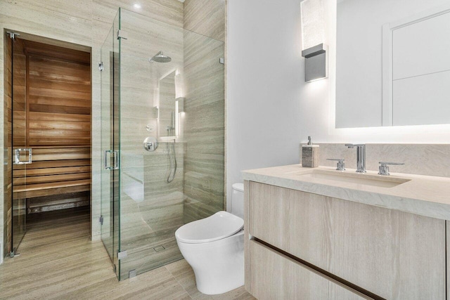 full bathroom with a shower stall, toilet, and vanity