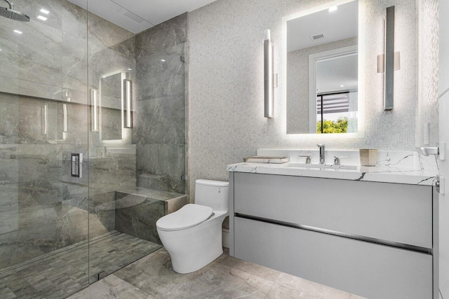 bathroom featuring toilet, a shower stall, visible vents, and vanity