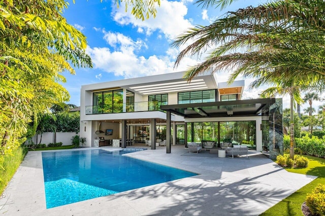 view of pool featuring a patio area, fence, an outdoor living space, and a fenced in pool