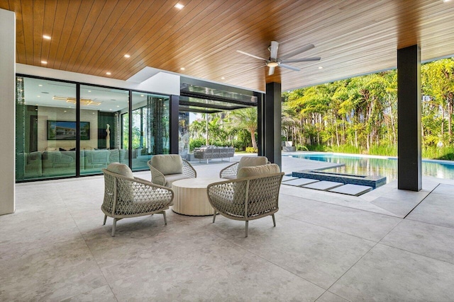 view of patio / terrace with an outdoor pool and a ceiling fan