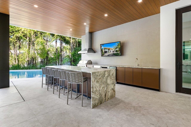 bar featuring floor to ceiling windows, recessed lighting, a sink, wall chimney range hood, and wooden ceiling