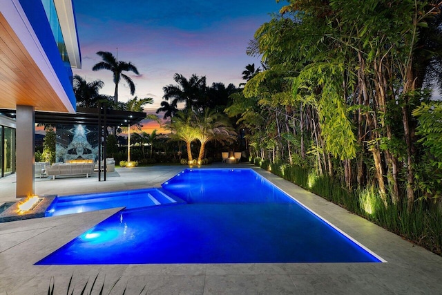 view of pool featuring a patio, a pool with connected hot tub, and an outdoor living space