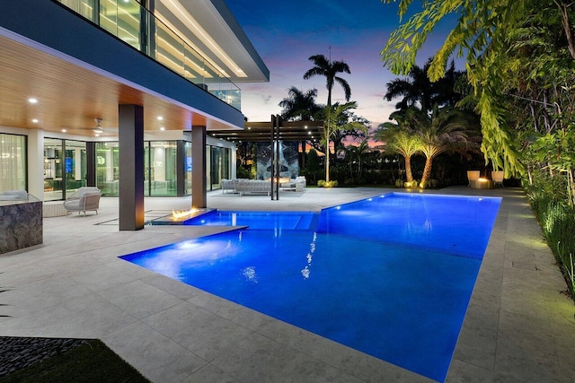 outdoor pool with a patio and a pergola