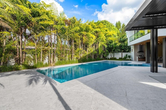 view of pool featuring a patio area, a grill, fence, and a fenced in pool