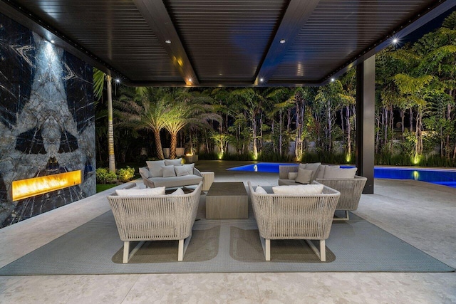 view of patio / terrace with an outdoor pool and an outdoor living space with a fireplace