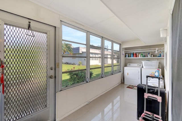 laundry room with washing machine and dryer and light tile patterned floors