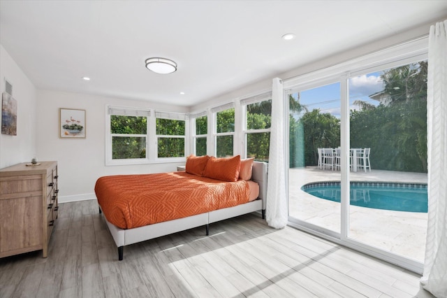 bedroom featuring access to outside and hardwood / wood-style floors